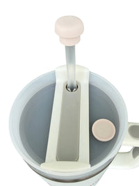 Pearl white silicone straw cap shown on a tumbler straw as a reusable straw cover